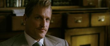 Movie still from “The Walker” (2007), directed by Paul Schrader – A person wearing a suit and tie; Close Up shot, Over the shoulder angle