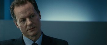 Movie still from “The Walker” (2007), directed by Paul Schrader – A man in a suit and tie looking at the camera; Close Up shot, Over the shoulder angle