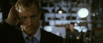 Movie still from “The Walker” (2007), directed by Paul Schrader – A person wearing a suit and tie; Close Up shot, Over the shoulder angle