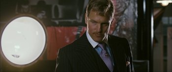 Movie still from “The Walker” (2007), directed by Paul Schrader – A man in a suit and tie looking to his left; Close Up shot, Low angle