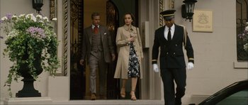 Movie still from “The Walker” (2007), directed by Paul Schrader – A man and a woman walking down the stairs; Wide shot, Low angle