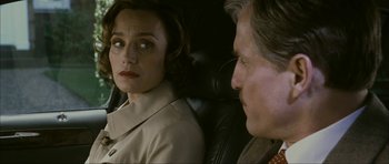 Movie still from “The Walker” (2007), directed by Paul Schrader – A man and a woman sitting in the back seat of a car; Close Up shot, Over the shoulder angle