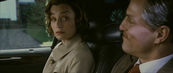 Movie still from “The Walker” (2007), directed by Paul Schrader – A man and a woman sitting in the back seat of a car; Close Up shot, Over the shoulder angle