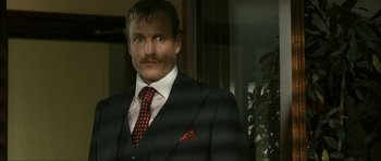 Movie still from “The Walker” (2007), directed by Paul Schrader – A person wearing a suit and a tie; Close Up shot, Low angle