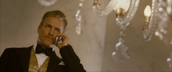 Movie still from “The Walker” (2007), directed by Paul Schrader – A man talking on a cell phone while wearing a suit and tie; Close Up shot, Low angle