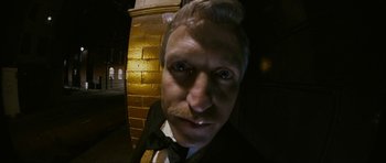 Movie still from “The Walker” (2007), directed by Paul Schrader – A person wearing a suit and bow tie; Close Up shot, Low angle