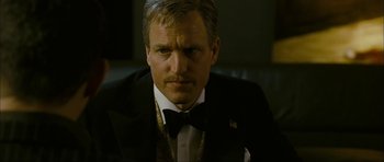 Movie still from “The Walker” (2007), directed by Paul Schrader – A person wearing a suit and a bow tie; Close Up shot, Over the shoulder angle