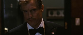 Movie still from “The Walker” (2007), directed by Paul Schrader – A person wearing a suit and a bow tie; Close Up shot, Over the shoulder angle