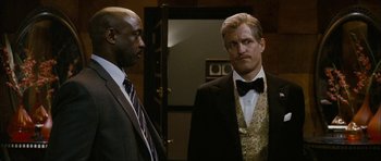 Movie still from “The Walker” (2007), directed by Paul Schrader – Two men standing next to each other in a room; Medium shot, Low angle