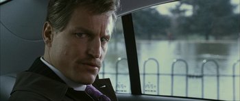 Movie still from “The Walker” (2007), directed by Paul Schrader – A person wearing a suit and tie in a car; Close Up shot, Low angle