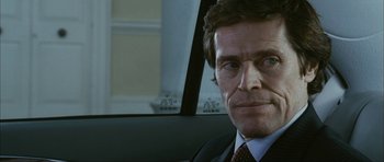 Movie still from “The Walker” (2007), directed by Paul Schrader – A person wearing a suit in a car; Close Up shot, Over the shoulder angle