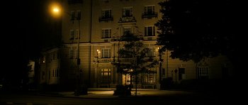 Movie still from “The Walker” (2007), directed by Paul Schrader – A building lit up at night by street lights; Extreme Wide shot, Low angle