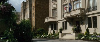 Movie still from “The Walker” (2007), directed by Paul Schrader – A building that has a flag on the front of the building; Extreme Wide shot, Low angle