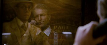 Movie still from “The Walker” (2007), directed by Paul Schrader – A man wearing a suit and tie talking on a cell phone; Close Up shot, Over the shoulder angle