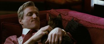 Movie still from “The Walker” (2007), directed by Paul Schrader – A man laying on a couch holding a cat; Close Up shot, Low angle