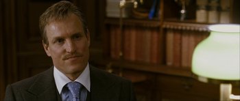 Movie still from “The Walker” (2007), directed by Paul Schrader – A person wearing a suit and tie; Close Up shot, Over the shoulder angle