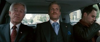 Movie still from “The Walker” (2007), directed by Paul Schrader – A man in a suit and tie sitting in the back of a car; Medium shot, Low angle