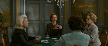 Movie still from “The Walker” (2007), directed by Paul Schrader – A group of people sitting at a table with cards; Medium shot, Over the shoulder angle