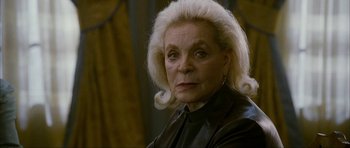 Movie still from “The Walker” (2007), directed by Paul Schrader – An older woman with blonde hair wearing a leather jacket; Close Up shot, Over the shoulder angle