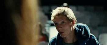 Movie still from “The Wave” (2008), directed by Dennis Gansel – A young man with blonde hair wearing a blue jacket; Close Up shot, Over the shoulder angle