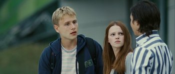 Movie still from “The Wave” (2008), directed by Dennis Gansel – A man and a woman standing next to each other; Close Up shot, Low angle