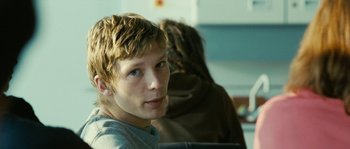 Movie still from “The Wave” (2008), directed by Dennis Gansel – A young man sitting in front of another man; Close Up shot, Over the shoulder angle