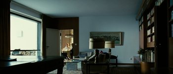 Movie still from “The Wave” (2008), directed by Dennis Gansel – Two people are sitting in a living room; Wide shot, Over the shoulder angle
