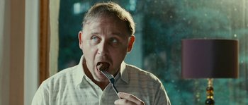 Movie still from “The Wave” (2008), directed by Dennis Gansel – A person with a fork in his mouth; Close Up shot, Low angle