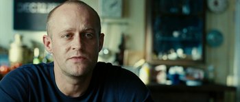 Movie still from “The Wave” (2008), directed by Dennis Gansel – A person sitting in a room; Close Up shot, Low angle
