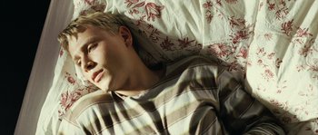 Movie still from “The Wave” (2008), directed by Dennis Gansel – A young man sleeping in a bed with a blanket; Close Up shot, Overhead angle