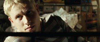 Movie still from “The Wave” (2008), directed by Dennis Gansel – A man laying in a bed looking at the camera; Close Up shot, High angle