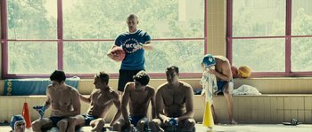 Movie still from “The Wave” (2008), directed by Dennis Gansel – A group of young men sitting on the ground; Wide shot, Over the shoulder angle