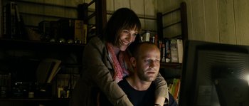 Movie still from “The Wave” (2008), directed by Dennis Gansel – A man and a woman pose for a picture; Medium shot, Low angle