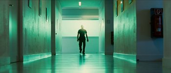 Movie still from “The Wave” (2008), directed by Dennis Gansel – A man walking down a hallway in a building; Wide shot, Low angle