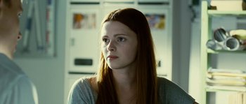 Movie still from “The Wave” (2008), directed by Dennis Gansel – A woman with long red hair is looking to her left; Close Up shot, Over the shoulder angle