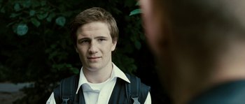 Movie still from “The Wave” (2008), directed by Dennis Gansel – A young man in a white shirt and a black vest; Close Up shot, Over the shoulder angle