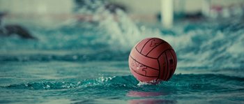Movie still from “The Wave” (2008), directed by Dennis Gansel – A water polo ball floating on top of a body of water; Extreme Close Up shot, Overhead angle