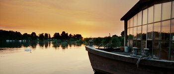 Movie still from “The Wave” (2008), directed by Dennis Gansel – A boat is sitting in the water at sunset; Extreme Wide shot, Low angle
