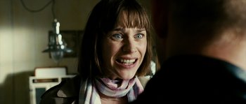 Movie still from “The Wave” (2008), directed by Dennis Gansel – A person with a scarf on smiling; Close Up shot, Over the shoulder angle