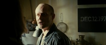 Movie still from “The Wave” (2008), directed by Dennis Gansel – A man with a bald head in a kitchen; Close Up shot, Low angle
