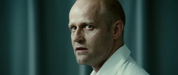 Movie still from “The Wave” (2008), directed by Dennis Gansel – A man with a bald head looking into the distance; Close Up shot, Low angle