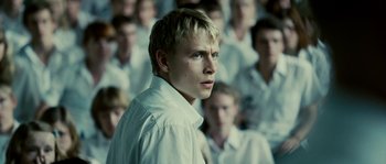 Movie still from “The Wave” (2008), directed by Dennis Gansel – A man standing in front of a group of people; Close Up shot, High angle