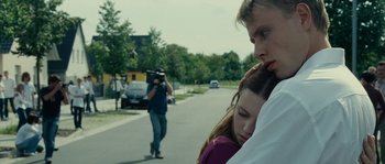 Movie still from “The Wave” (2008), directed by Dennis Gansel – A man taking a picture of a woman and a man; Close Up shot, Over the shoulder angle