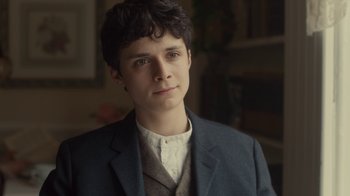 Movie still from “Anne with an E” (2017), created by Moira Walley-Beckett – A young man in a suit is looking at the camera; Close Up shot, Over the shoulder angle