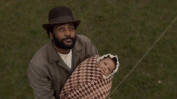 Movie still from “Anne with an E” (2017), created by Moira Walley-Beckett – A man holding a baby wrapped in a blanket; Close Up shot, Overhead angle
