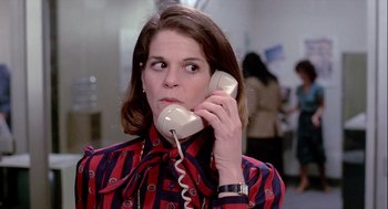Movie still from “The Woman in Red” (1984), directed by Gene Wilder – A woman holding a phone up to her ear; Close Up shot, Low angle