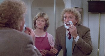 Movie still from “The Woman in Red” (1984), directed by Gene Wilder – A man and a woman in the mirror shaving; Close Up shot, Over the shoulder angle