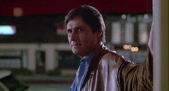 Movie still from “The Woman in Red” (1984), directed by Gene Wilder – A person wearing a jacket and a tie; Close Up shot, Low angle