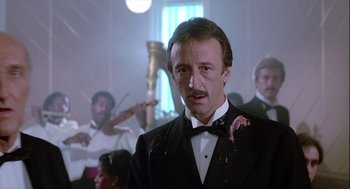 Movie still from “The Woman in Red” (1984), directed by Gene Wilder – A person wearing a suit and tie; Close Up shot, Low angle