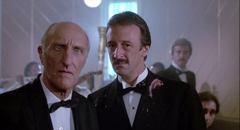 Movie still from “The Woman in Red” (1984), directed by Gene Wilder – Two men in tuxedos standing next to each other; Close Up shot, Low angle